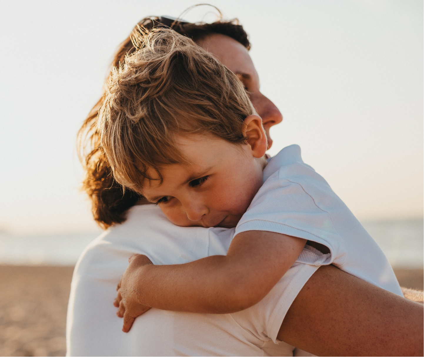 Young child hugging parent