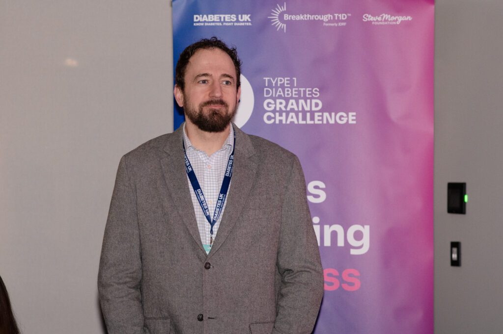 Matt Webber at the Grand Challenge dinner in Glasgow, there's a Grand Challenge branded banner behind him
