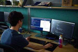 Teifion Luckett from Sarah's team, looking at data for their research on a monitor screen