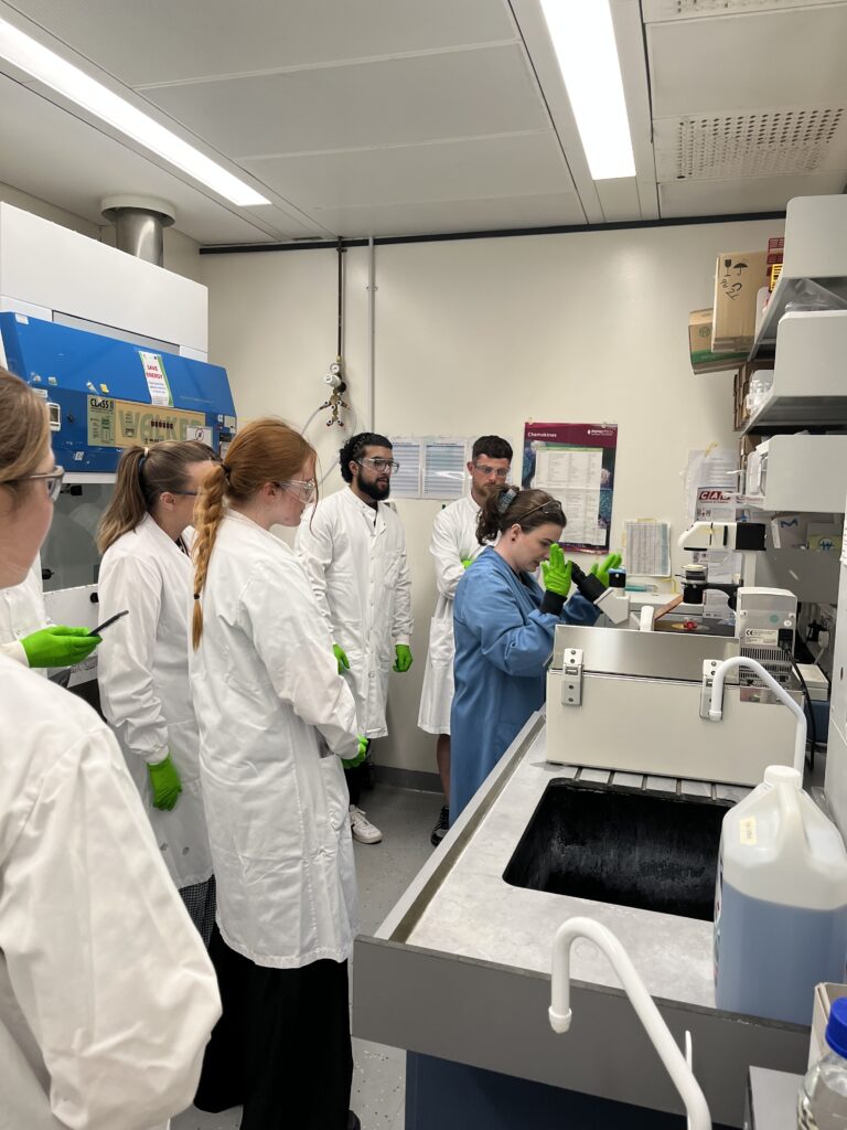Students watching researcher in the lab